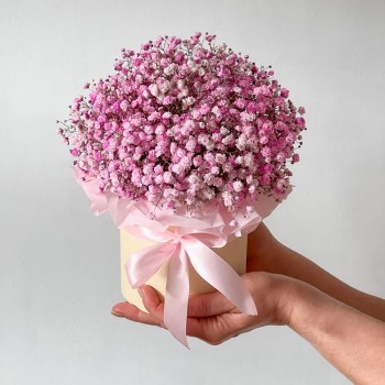 Composition of pink gypsophila in a hat box Bouquet